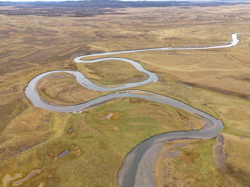 A winding river cuts through the landascape - the perfect setting for Flyfishing for trout and salmon
